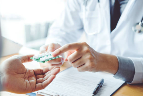 Pharmacist handing a patient their specialty medication